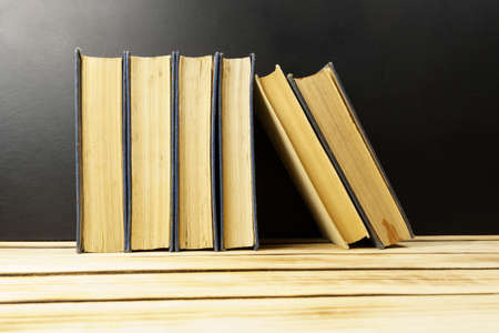 Vintage old books on a wooden background. Background from books. Education. World book day