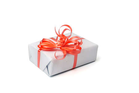 White gift box with a silver bow on white background. Surprise gift with red ribbon