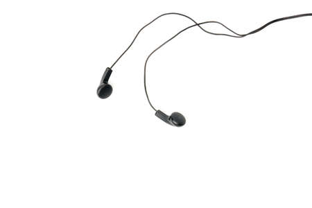 Black headphones isolated on white background. Simple wired headphones from the phoneの写真素材