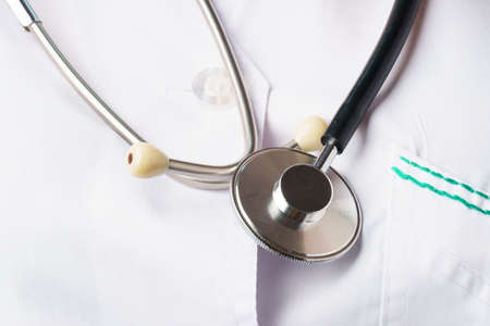 Close-up of a medical stethoscope on a white coat. Medicine and healthcareの写真素材
