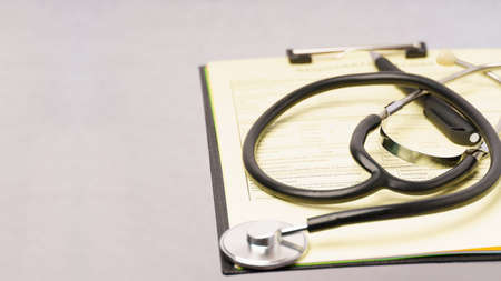 Patient history form and stethoscope. Gray background with copy space for writing text. Selective focus.Medical concept.の写真素材
