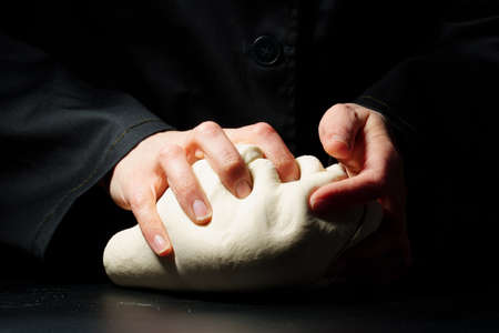 Dough preparation on a dark background. Food concept. Cooking processの写真素材