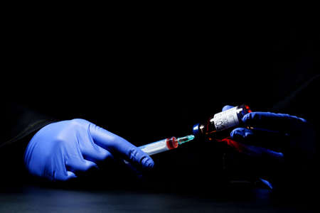 syringe coronavirus vaccine on dark background. Coronavirus treatment concept, vaccine injection.の写真素材