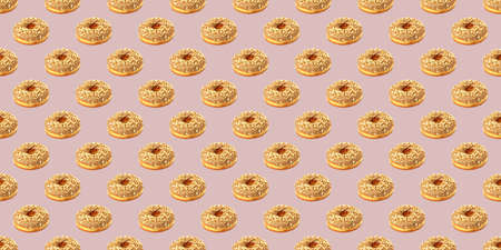 Pattern from chocolate donuts on a beige background. Chocolate donuts pattern. Flat lay.