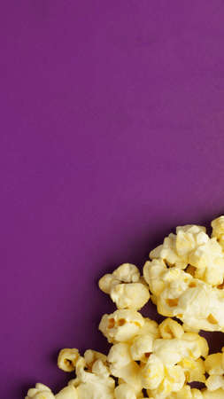 cooked popcorn on a violet background with copy space. Leisure conceptの写真素材