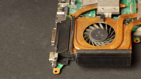 close-up of laptop fan on dark background with copy space. computer repair and cleaning