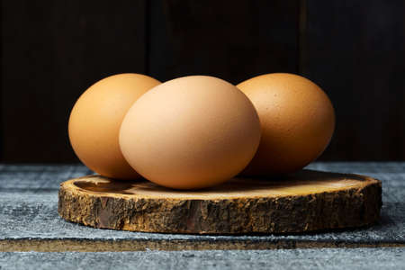 fresh chicken eggs on a wood black table with copy space. menu layoutの写真素材