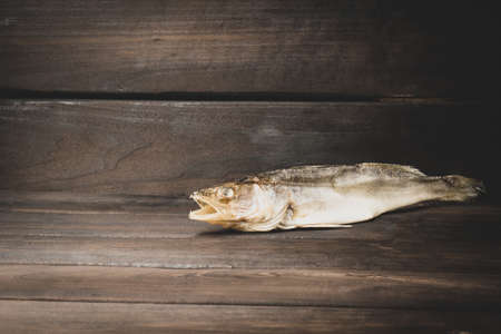 pike perch, dried salted fish, on dark wood background with copy spaceの写真素材