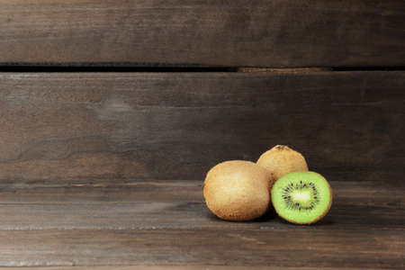 ripe kiwi on a dark wooden background. banner with copy space
