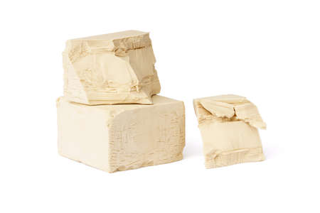 fresh pressed yeast blocks isolated on white background. raw yeastの写真素材