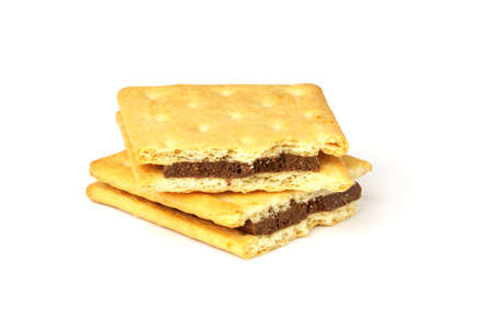 cracker cookies isolated on white background. two halves of a cookie with a chocolate layer.の写真素材