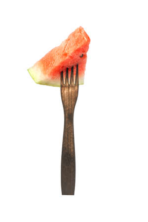 slice of watermelon on a fork isolated on white background.の写真素材