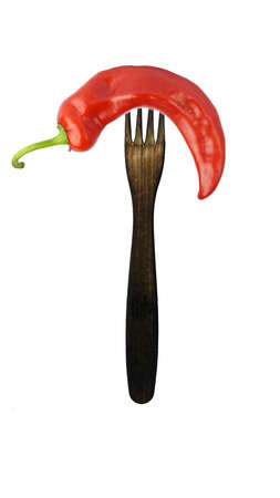 chili peppers on a fork isolated on white background. hot peppers