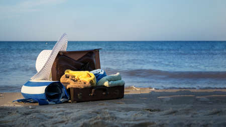 old brown suitcase on the seashore. free space for textの写真素材