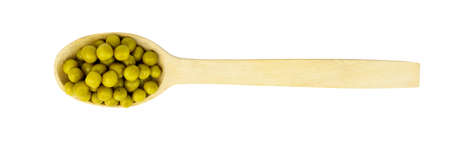 top view of wooden spoon with green canned peas isolated on white backgroundの写真素材