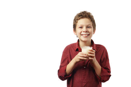 happy boy with glass of milk isolated on whiteの写真素材