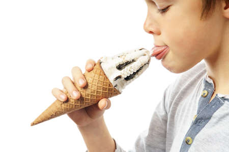 boy licking ice cream isolated on whiteの写真素材