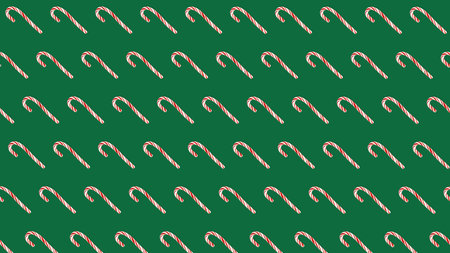 striped caramel lollipops on a green background. seamless new year christmas backgroundの写真素材