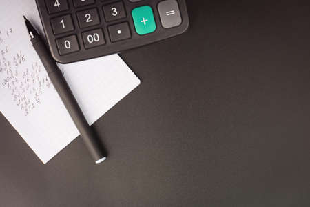 calculator on a notepad with numbers and a pen. business accounting and finance concept. top viewの写真素材