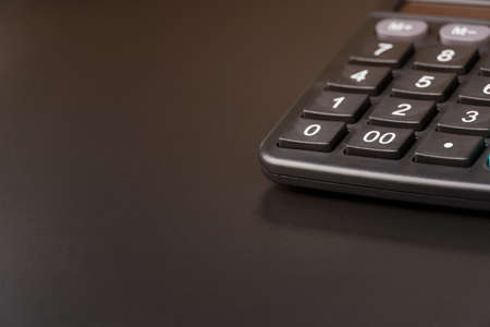 calculator on a dark black table background with empty copy spaceの写真素材