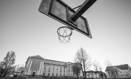 old school building and basketball hoop, black and whiteの写真素材