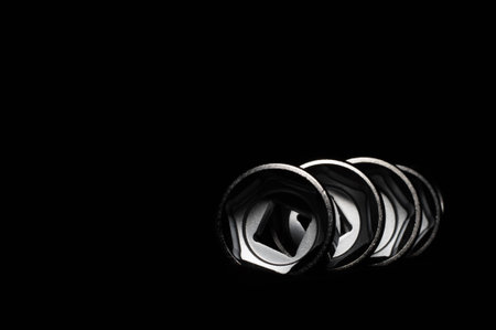 Set of chrome wrenches on black background. Close up.