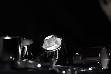 Set of chrome wrenches isolated on black background. Close up.