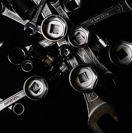 Set of chrome wrenches on black background. Close up.