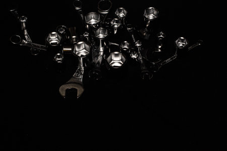 Set of chrome wrenches isolated on black background. Close up.