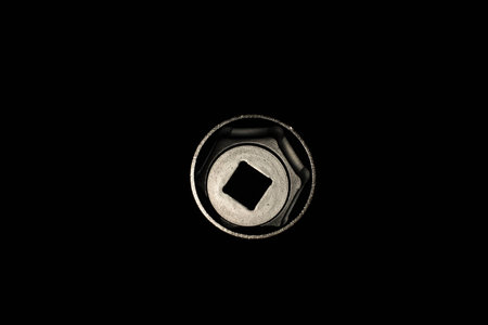 Chrome wrench isolated on black background. Close up.