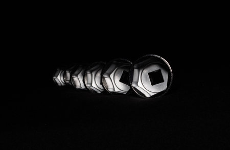 Set of chrome wrenches isolated on black background. Close up.