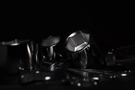 Set of chrome wrenches isolated on black background. Close up.