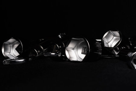 Set of chrome wrenches isolated on black background. Close up.