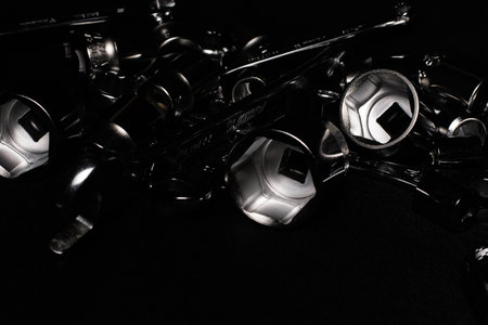 Set of chrome wrenches isolated on black background. Close up.