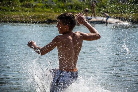 Kids playing in water, jumping, swiming. Summer. Fun.のeditorial素材