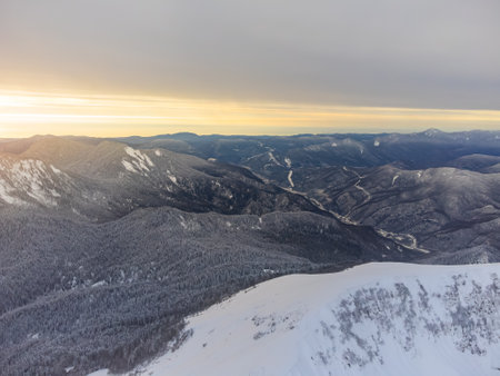 View of the winter sunset and snow-covered mountains in Sochiの写真素材