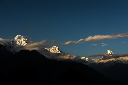 Annapurna South along with Mount Machapuchare (Fishtail) visible in the evening glow from Tadapani, Nepal during Khopra Ridge trekの写真素材
