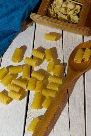 rigatoni traditional italian food on white table