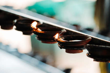 Burning clay oil lamps flame and smoke close upの写真素材
