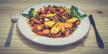 Plate of deviled prawns with fork and knifeの写真素材