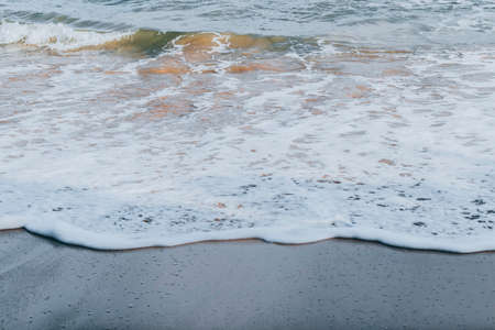 Calm sea waves wash over beautiful sand of the jungle beachの写真素材