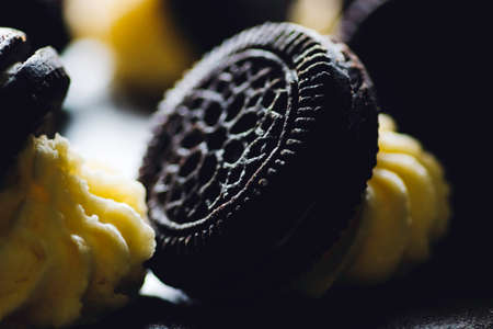 Chocolate icing cake dark chocolate biscuits on topping close up macro