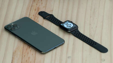 Galle, Sri Lanka - 02 19 2021: Apple iPhone 11 pro max and apple watch series 6 lay flat parallel to...