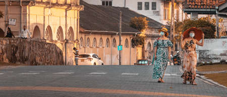Galle, Southern Province, Sri Lanka - 02 12 2021: Tourists enjoying the evening, walking around scenic streets in Galle Fort, an Iconic and historic landmark for a family vacation.のeditorial素材