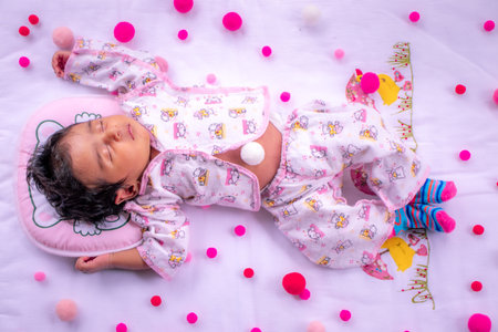 1-Month-old cute baby girls birthday celebration, sleeping in a pink fluffy pillow and matt, Napping...