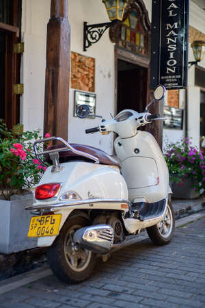 White retro style modern scooter bike parked in the streets, rearview shot.のeditorial素材