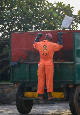 Galle, Sri Lanka - 03 05 2022: old woman sitting on the balcony and listening to the music on the headset.のeditorial素材