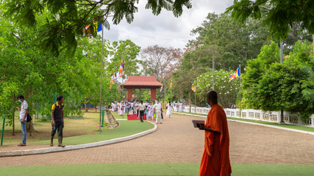 Anuradhapura, Sri Lanka: 03 31 2021: Devotees and a Buddhist monk in the streets of Sacred Jaya Sri Maha Bhodi.のeditorial素材