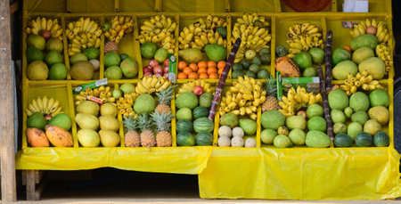 Various tropical fruits are on display on the stall stand.の写真素材