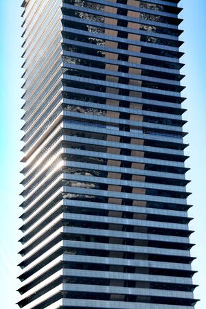 Business skyscraper building, blue glass, clean sky background